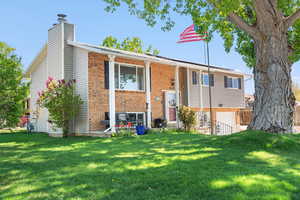 View of front of property with an attached garage and brick siding
