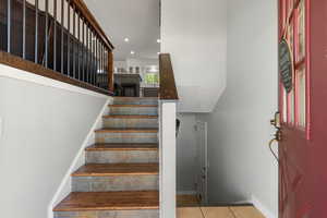 Stairs, recessed lighting, and tile patterned flooring