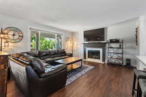 Living room featuring a high end fireplace and wood finished floors