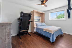 Bedroom featuring baseboards, a ceiling fan, a textured ceiling, and wood finished floors