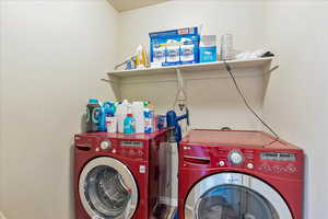 Laundry area featuring separate washer and dryer and laundry area