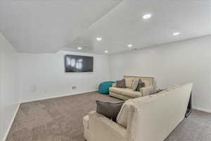 Living room featuring recessed lighting, baseboards, and carpet
