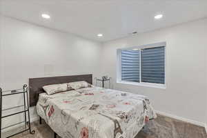 Bedroom featuring baseboards, carpet flooring, recessed lighting, and visible vents