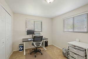 Office area with baseboards and carpet flooring