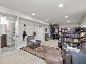Carpeted living room with baseboards, visible vents, and recessed lighting