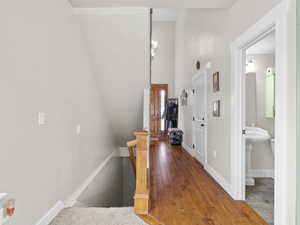 Corridor with baseboards and an upstairs landing