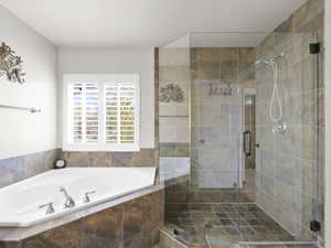 Full bath with a garden tub and a shower stall