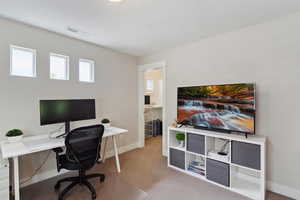 Carpeted office featuring visible vents and baseboards