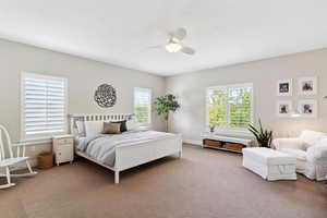 Bedroom featuring baseboards, a ceiling fan, and carpet flooring