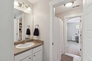 Full bath featuring vanity, tile patterned flooring, and visible vents