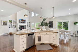 Kitchen featuring visible vents, open floor plan, dark wood-style floors, a sink, and dishwasher