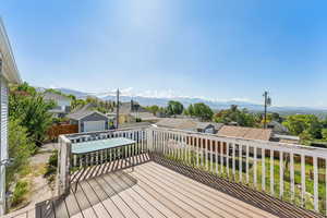 Deck with a residential view and a mountain view