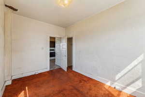Interior space with carpet floors and baseboards