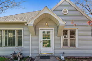 Property entrance with roof with shingles