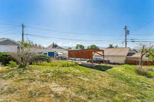View of yard with fence and a detached carport