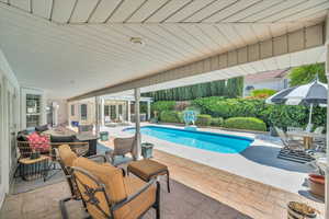 Outdoor pool with outdoor dining space, an outdoor living space, and a patio area