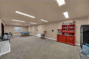 Recreation room with carpet floors and baseboards