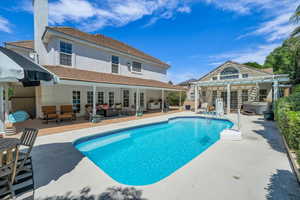 Outdoor pool featuring french doors, a hot tub, an outdoor hangout area, a patio, and a pergola