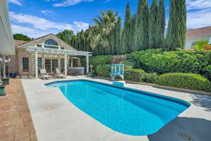Outdoor pool with a pergola, a patio, and a jacuzzi