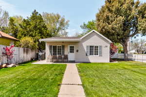 Back of property with a yard, a patio, and a fenced backyard