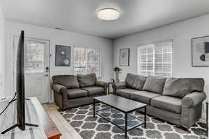 Living room with visible vents and tile patterned floors