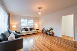 Living area with baseboards and light wood finished floors