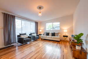 Living area featuring baseboards and light wood finished floors