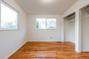 Unfurnished bedroom featuring baseboards and light wood-style floors