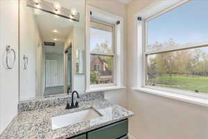 Bathroom with a wealth of natural light and vanity