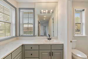 Bathroom featuring vanity and toilet