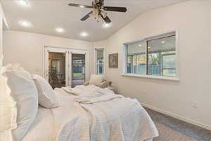Carpeted bedroom featuring baseboards, recessed lighting, ceiling fan, and vaulted ceiling