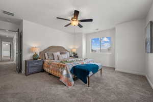 Bedroom featuring a ceiling fan, baseboards, visible vents, and carpet
