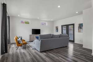 Living area with recessed lighting, dark wood finished floors, and baseboards