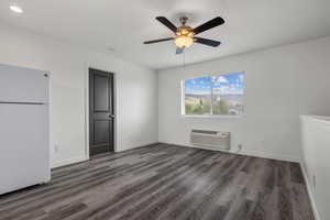 Unfurnished bedroom featuring freestanding refrigerator, a ceiling fan, baseboards, recessed lighting, and wood finished floors