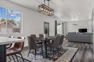 Dining room featuring an inviting chandelier, recessed lighting, and wood finished floors