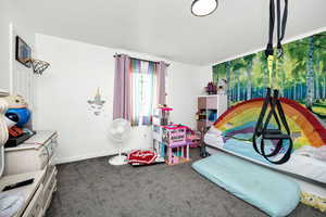 Rec room featuring carpet floors and baseboards