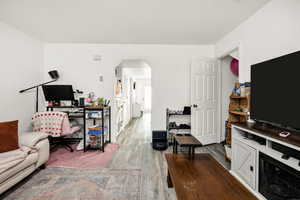 Living area featuring arched walkways and new laminate tile flooring