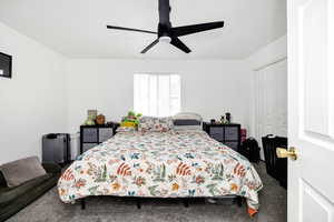 Bedroom featuring carpet floors, ceiling fan, and a closet