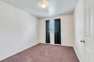 Spare room with carpet flooring, baseboards, and visible vents