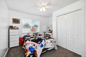 Bedroom with a ceiling fan, and a closet