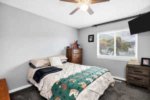 Bedroom featuring baseboards, visible vents, ceiling fan, and carpet