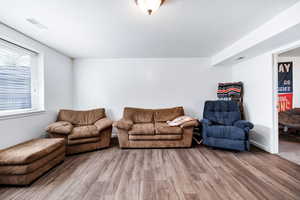 Living area with wood finished floors and visible vents