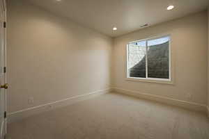 Empty room featuring baseboards, carpet flooring, recessed lighting, and visible vents