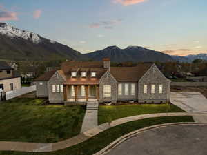 View of front of property with a mountain view, fence, covered porch, and a chimney