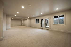 Empty room featuring recessed lighting, baseboards, and light colored carpet