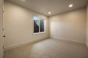 Spare room featuring carpet floors, baseboards, recessed lighting, and visible vents