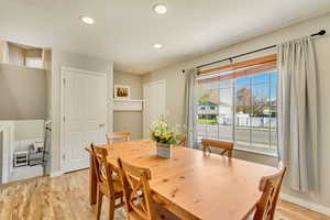 Dining room with baseboards, recessed lighting, and light wood-style flooring