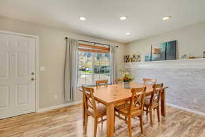 Dining space featuring baseboards, recessed lighting, and light wood-style flooring