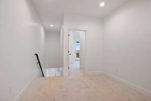 Corridor featuring baseboards, carpet flooring, recessed lighting, and an upstairs landing
