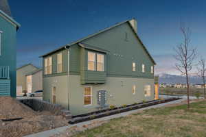 View of home's exterior featuring a chimney, a mountain view, and stucco siding